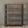 The Broadway Bookcase, a five-tier unit with a minimalist design, stands against a textured gray wall. Its shelves are crafted from medium-toned wood supported by a sleek black metal frame. The bookcase is currently empty, and the floor beneath is made of neutral-toned wood, evoking the understated elegance reminiscent of Broadway's finest sets.