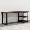 The Loredo Desk is a contemporary console table with a dark wooden top and sleek black metal frame. Its open design includes two wooden shelves positioned on the right side. Situated against a white wall on a gray floor, it shares space with a segment of a patterned rug in the foreground.