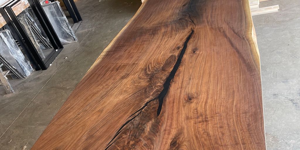 A large, polished wooden slab with a natural edge.