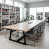 Modern conference table with natural wood top and black steel base in bright office with white bookshelves and gray chairs